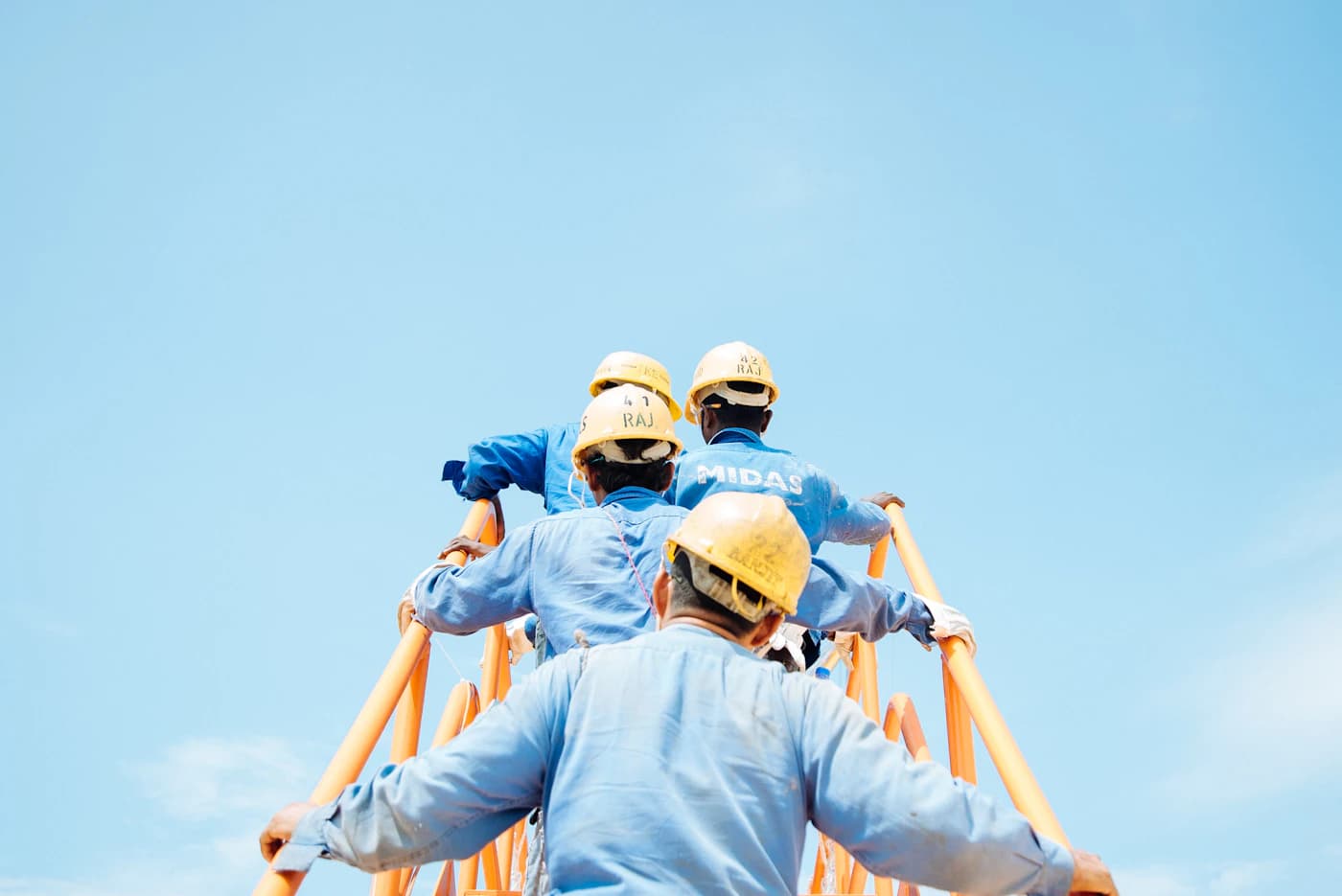 Site team in safety helmets reviewing work