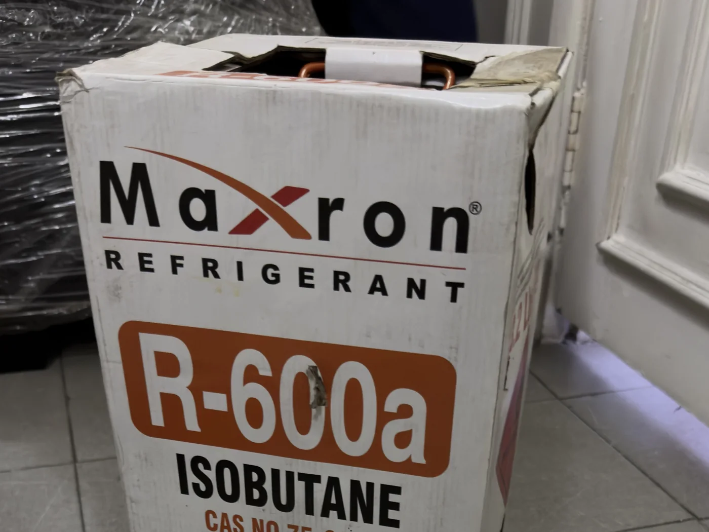 Carton of Maxron R-600a isobutane refrigerant in the store