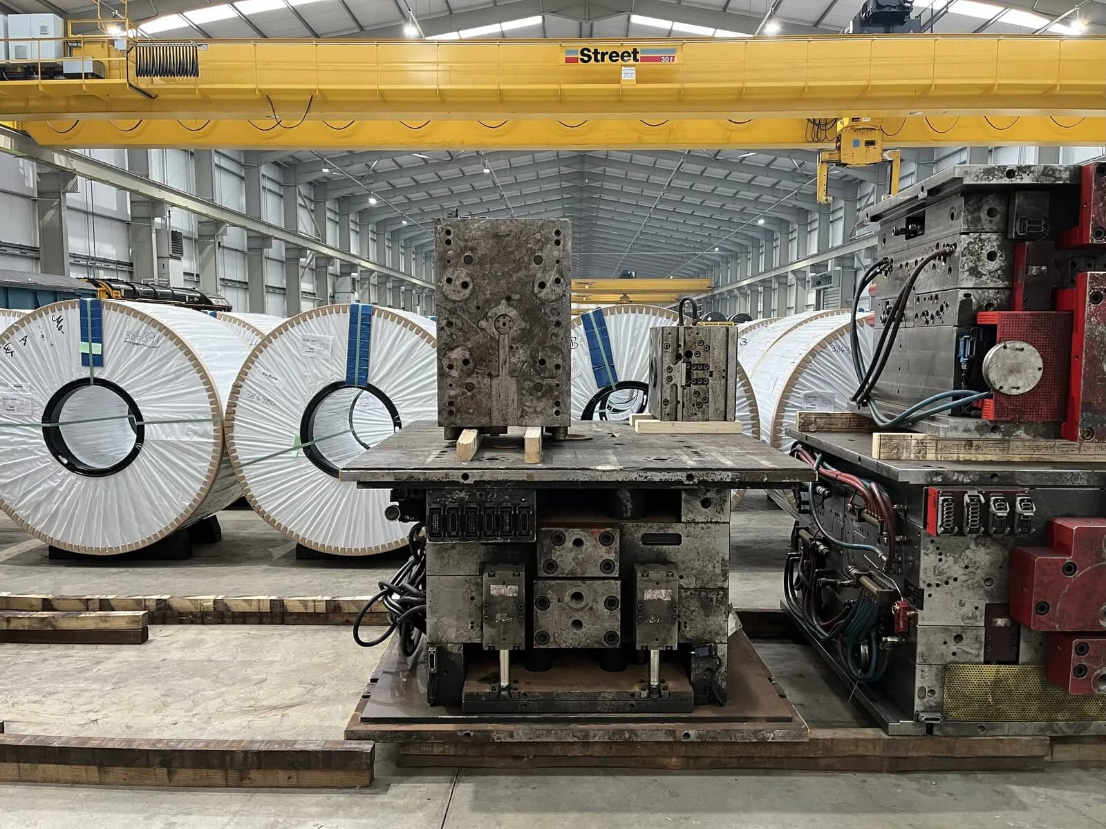 Mild steel sheet coils staged in a processing plant