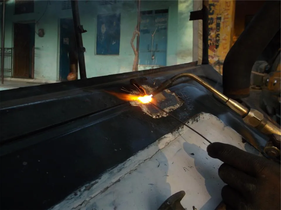 Oxy-fuel torch cutting steel plate